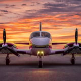 Cessna 414 Twin-Engine Aircraft on Runway at Sunset
