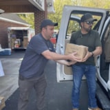 Volunteers unload medical supplies for Judah 1 mission relief