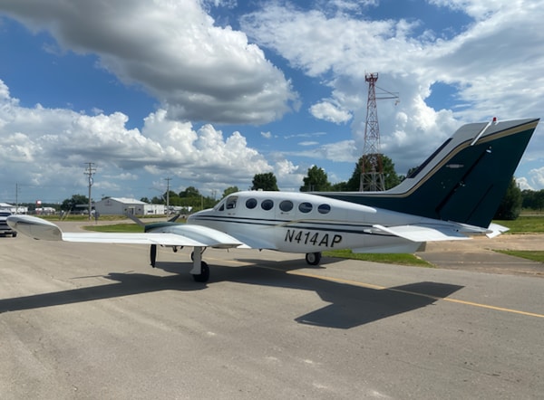 Cessna 414 pressurized twin-engine aircraft on airport ramp